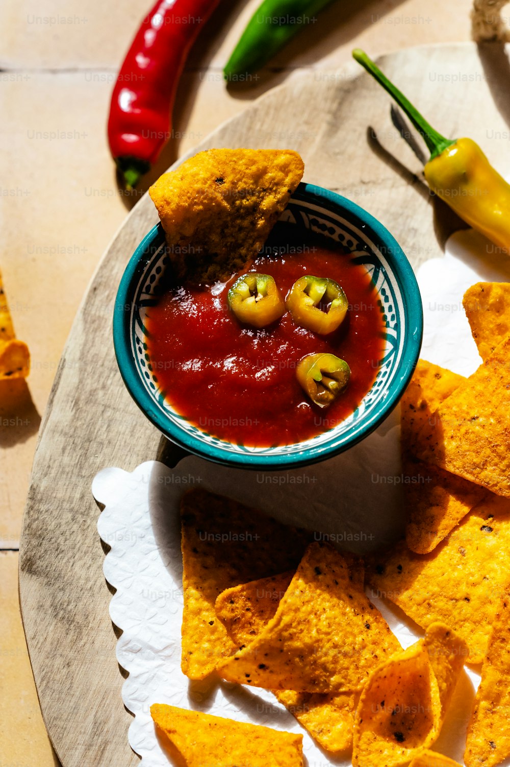 a bowl of salsa and tortilla chips on a plate