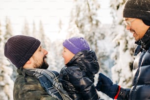 a man and a little boy standing in the snow