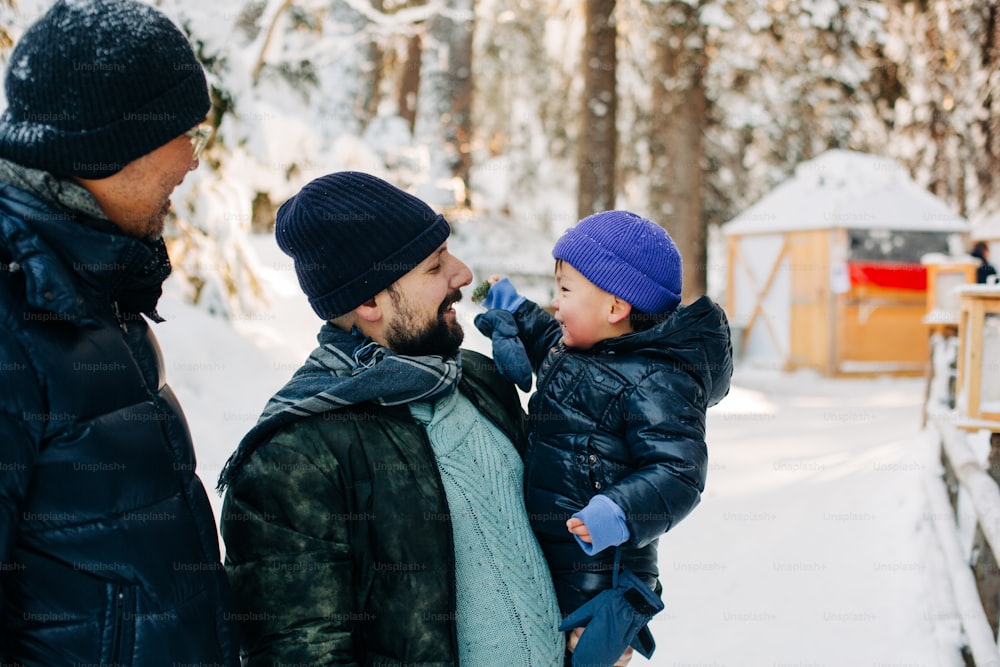 a man and a child standing in the snow