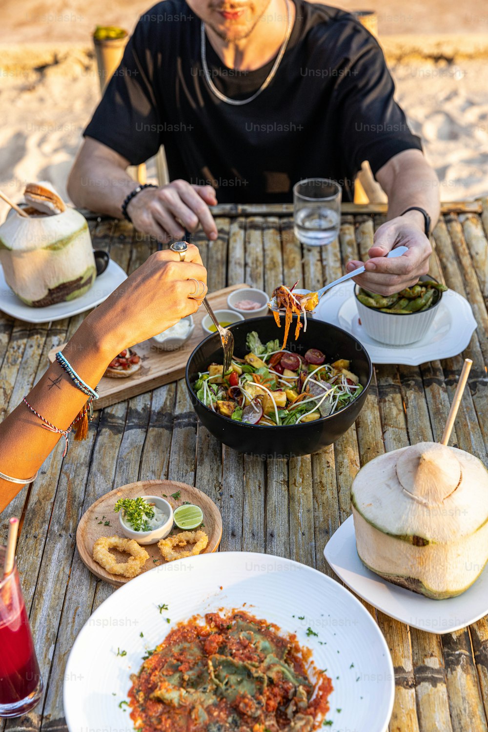 a man sitting at a table with plates of food