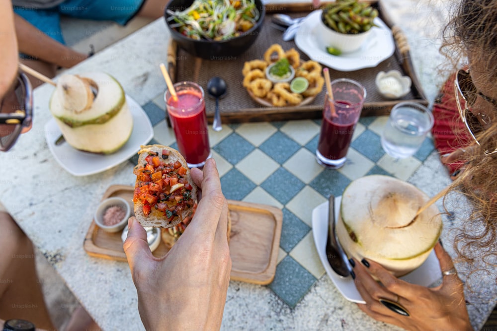 a group of people sitting around a table eating food