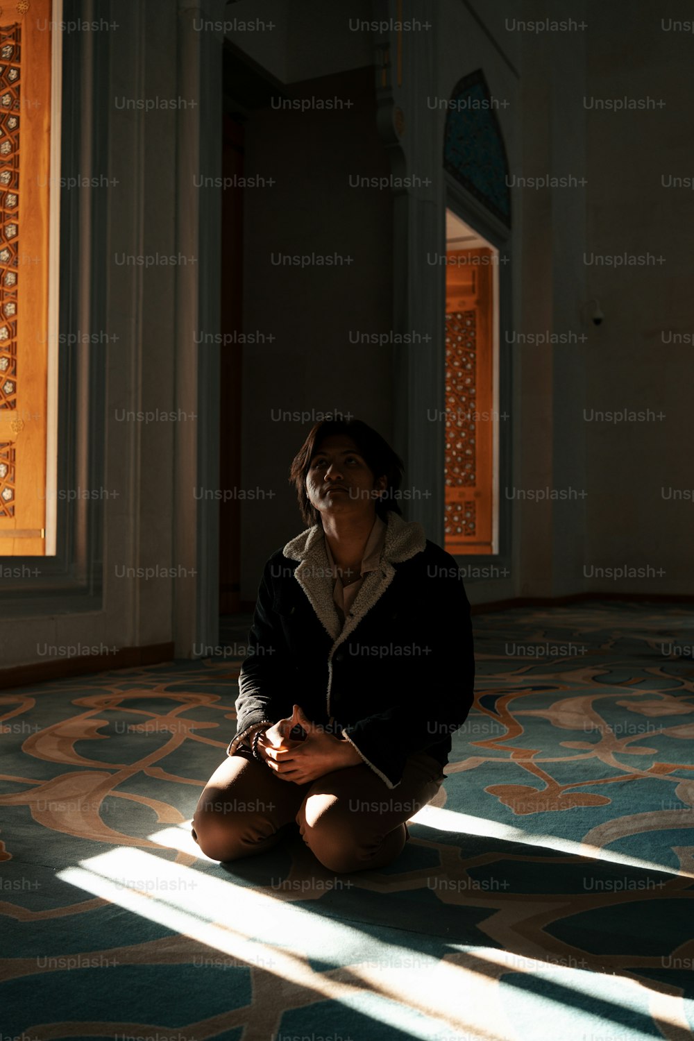 a woman sitting on the floor in a room