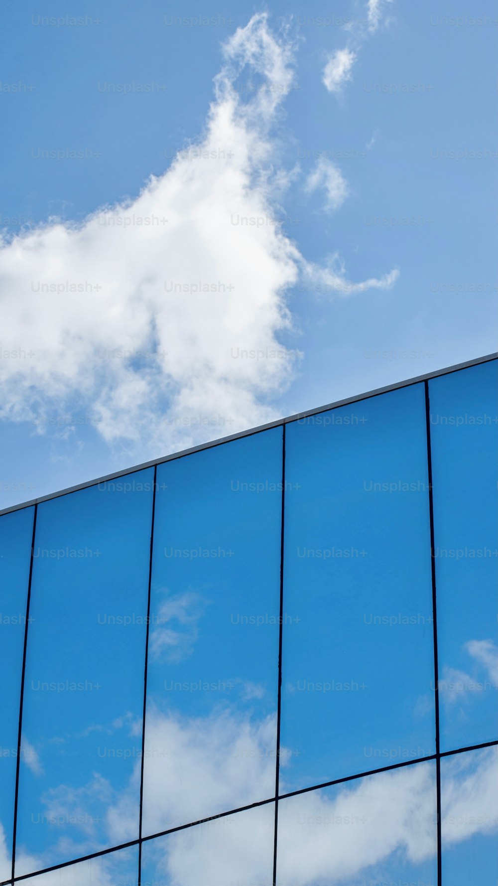 the reflection of the sky in the windows of a building