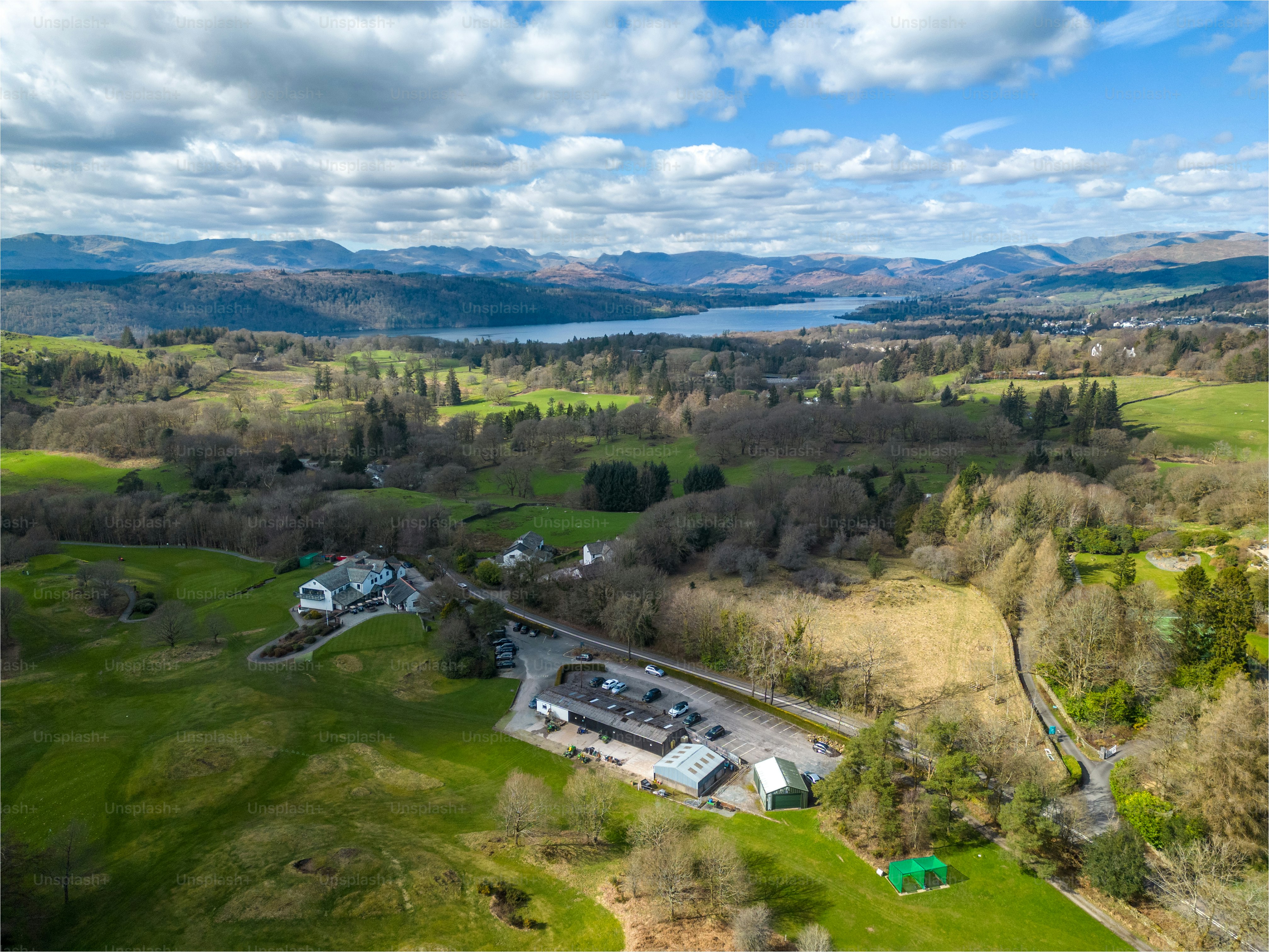 a bird's eye view of a large estate with a lake in the background