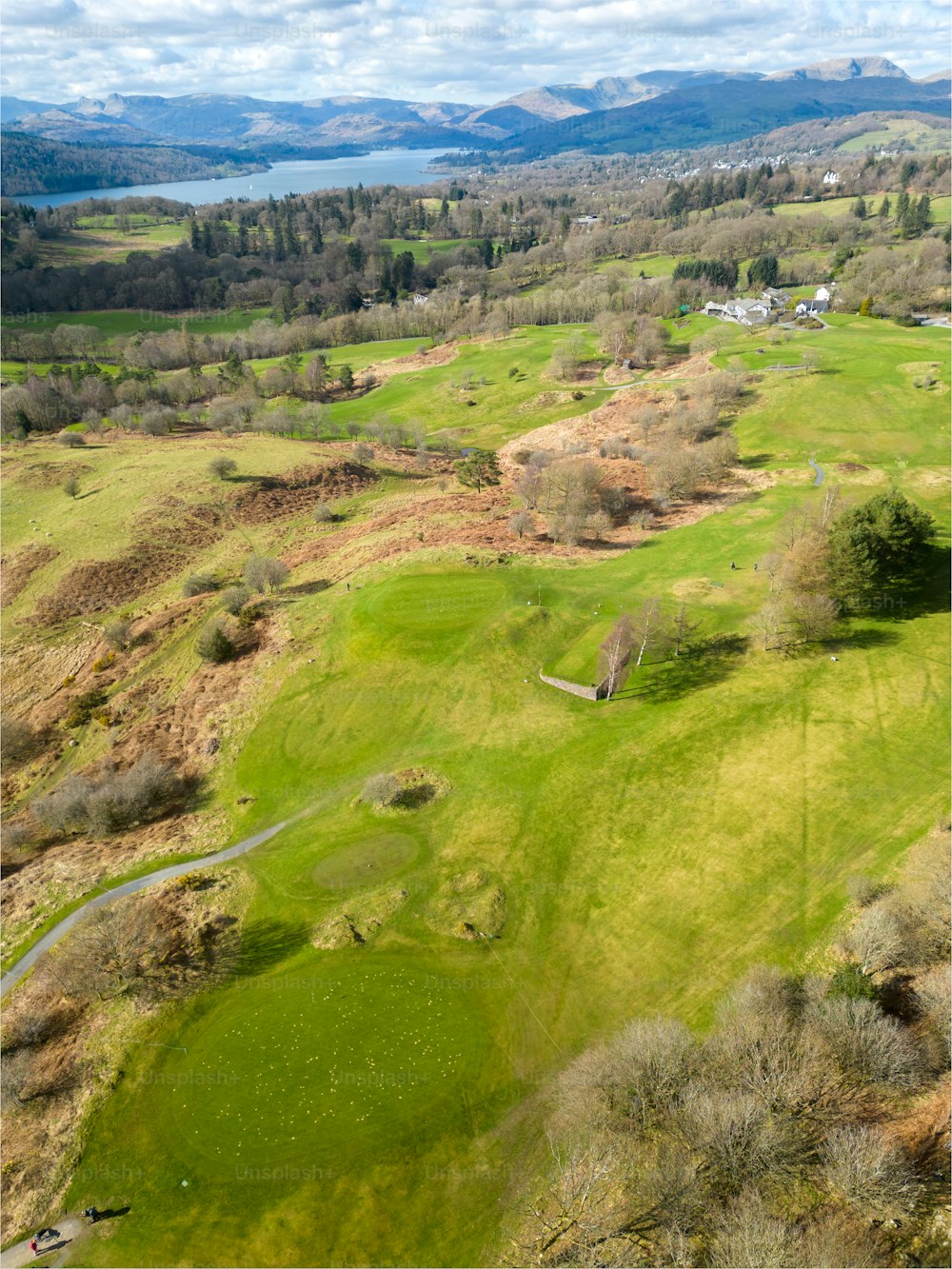 an aerial view of a golf course in the mountains