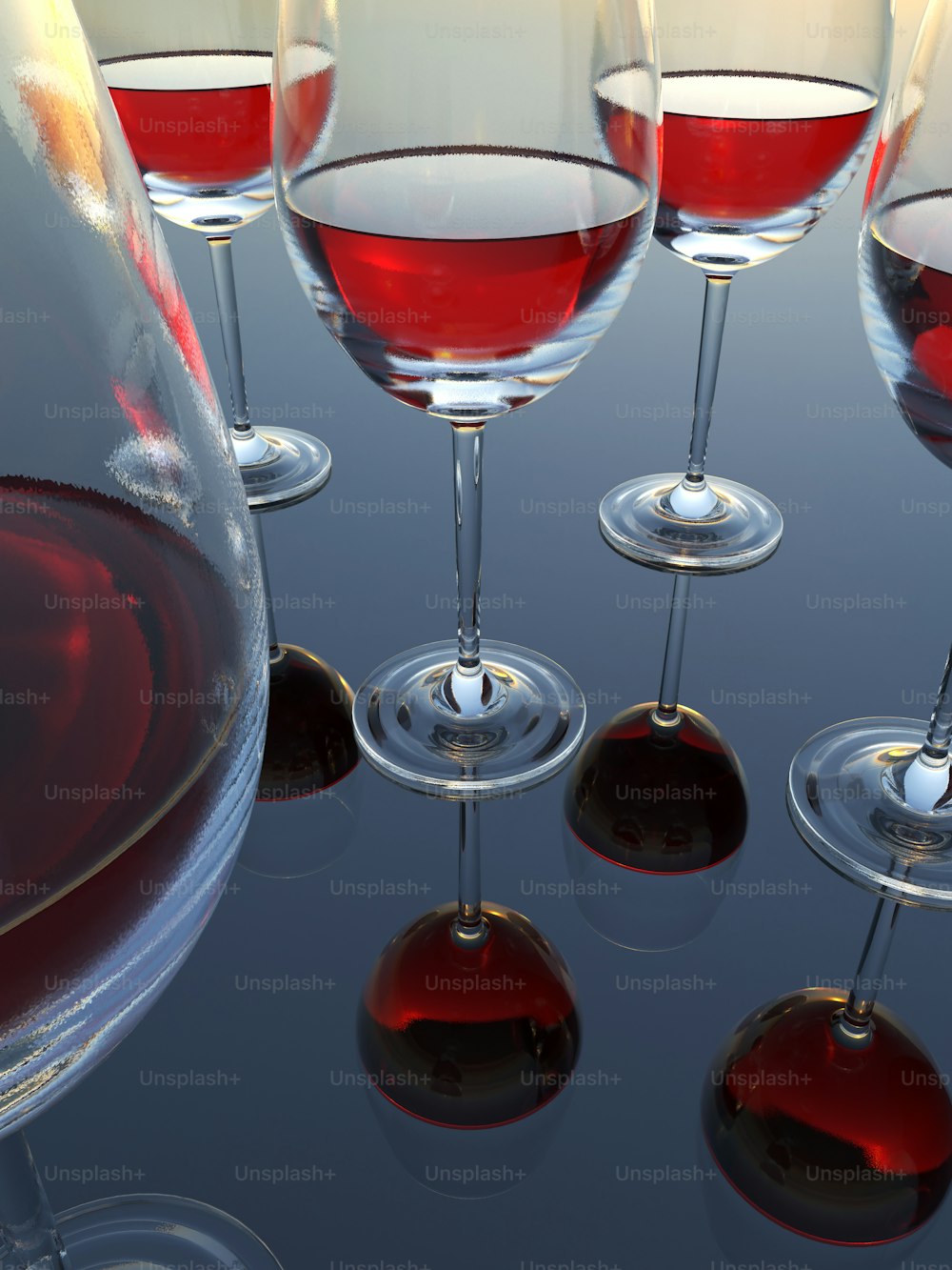 a group of wine glasses filled with red wine