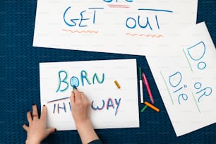 La scrittura a mano di un bambino su carta con pastelli colorati