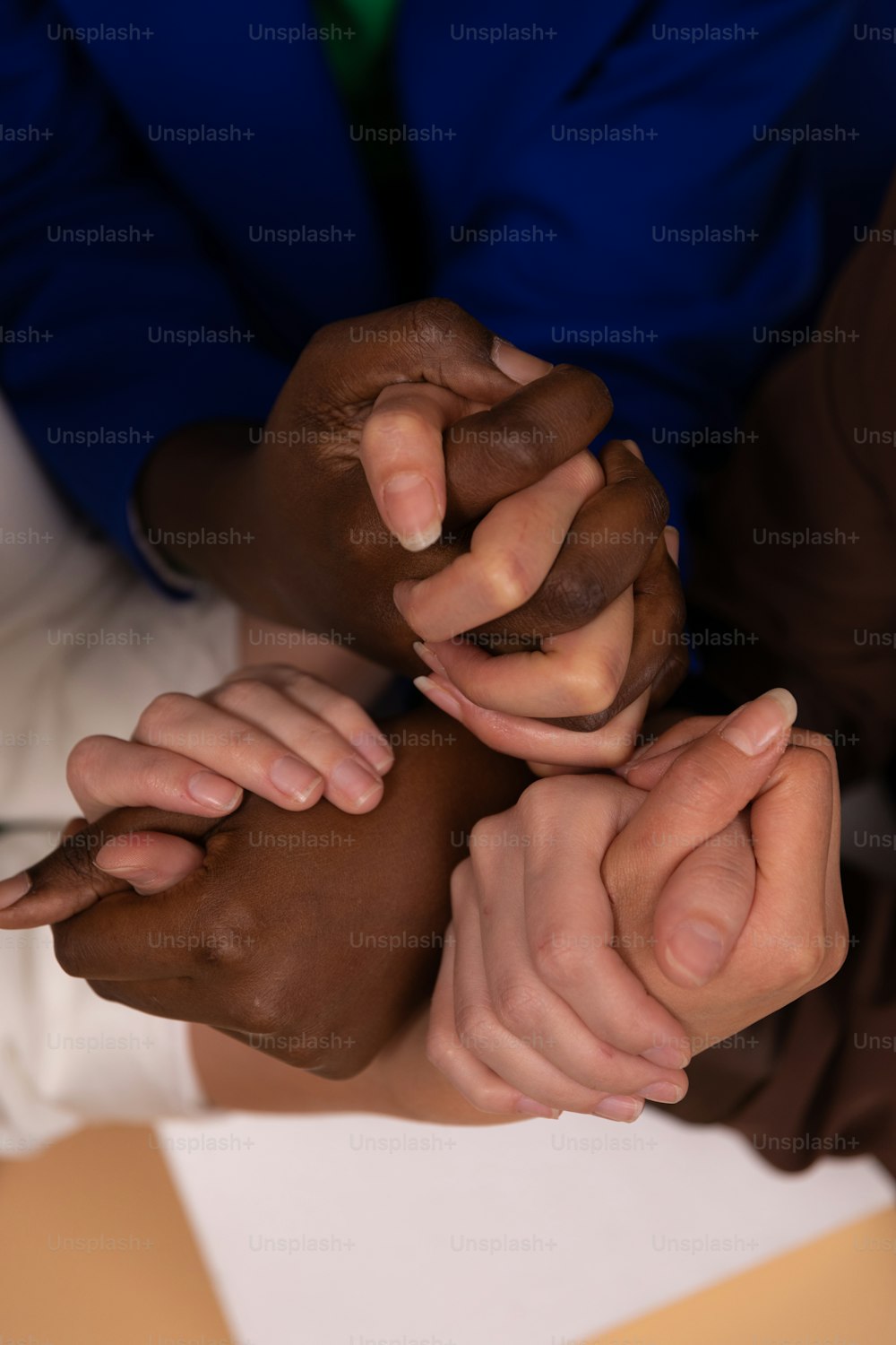 a group of people holding their hands together
