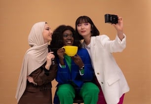 three women taking a picture with a camera
