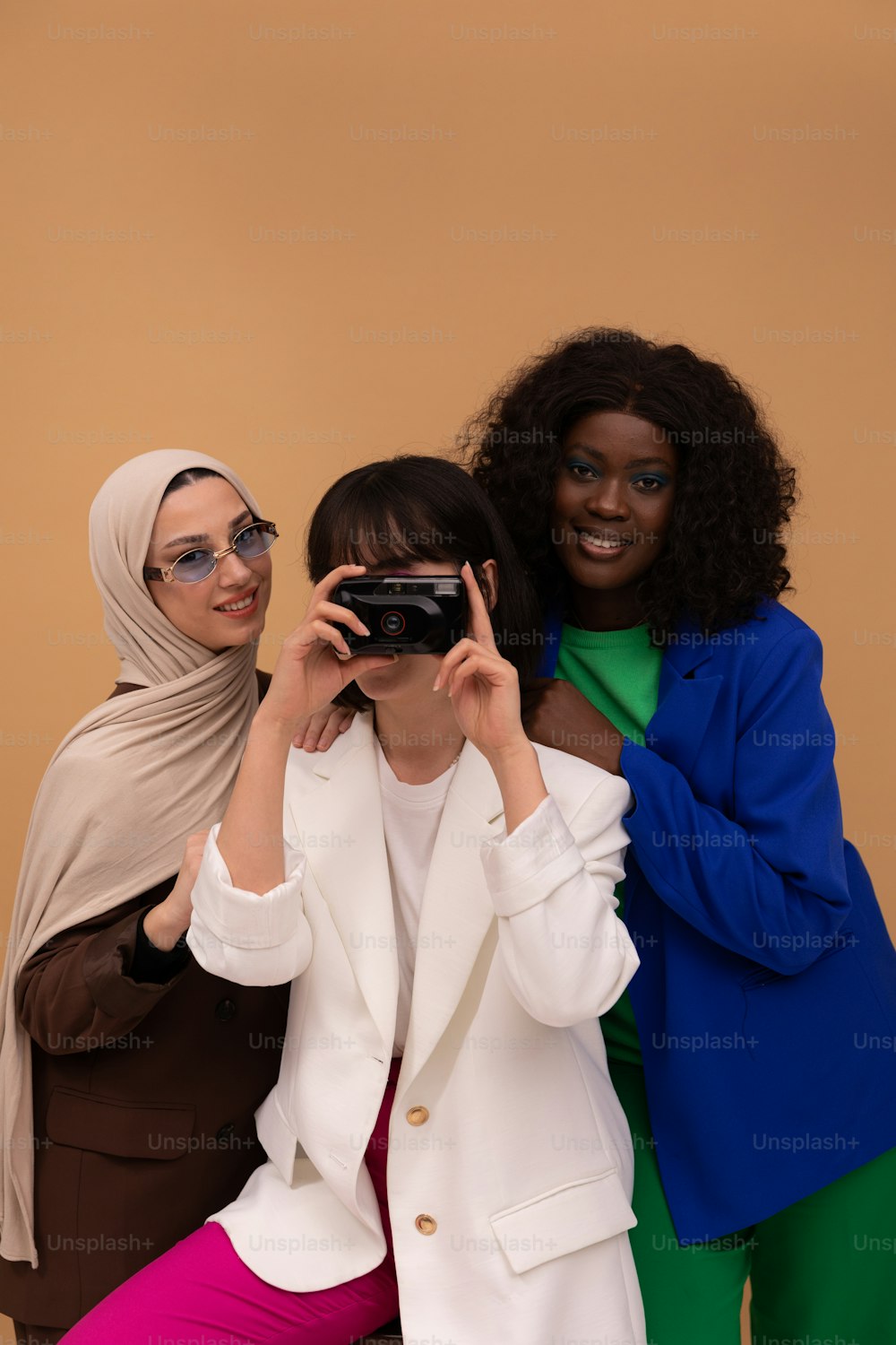 three women are taking a picture with a camera