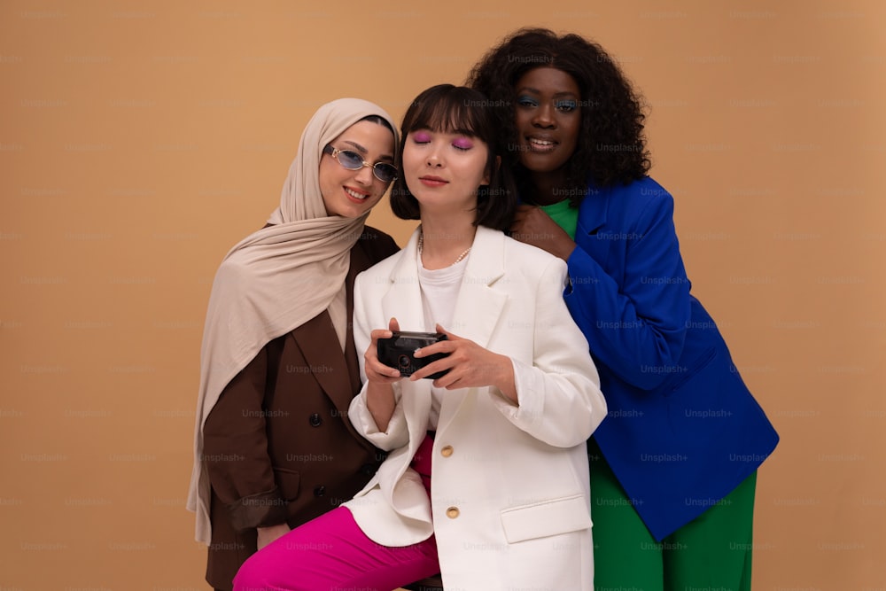 a group of three women standing next to each other