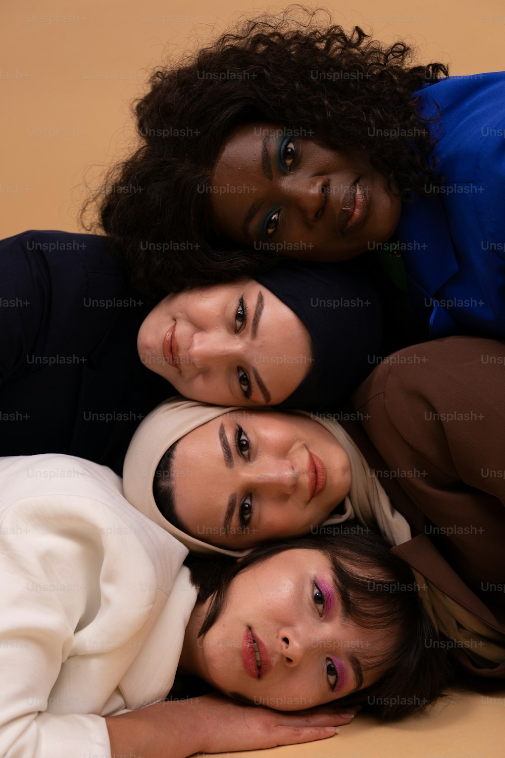 a group of three women laying on top of each other