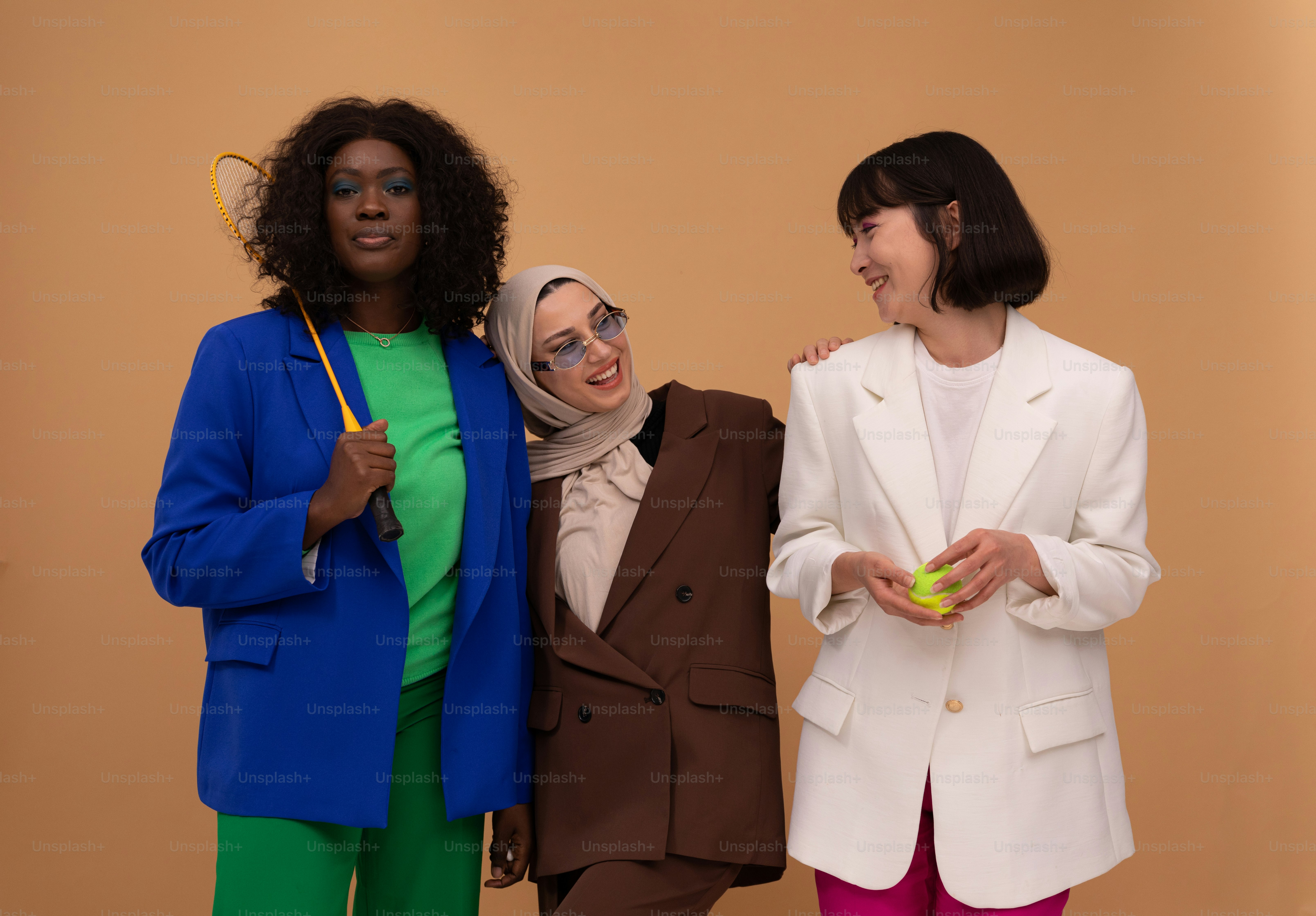 a group of three women standing next to each other