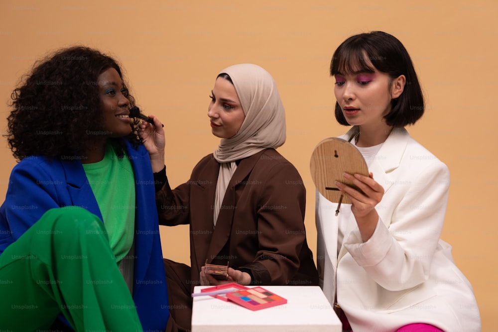 a group of three women sitting next to each other