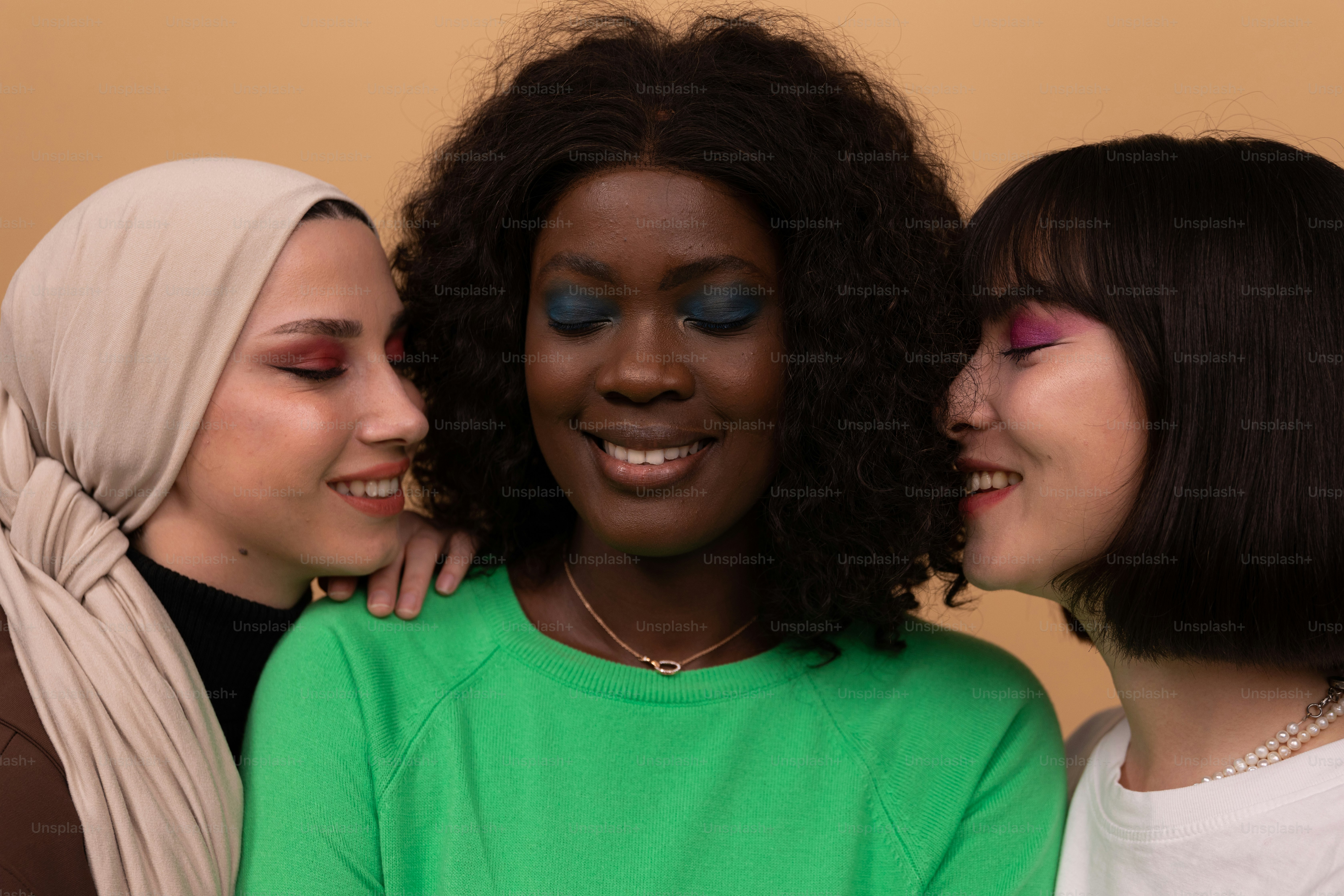 A group of three women standing next to each other photo – Fashion ...