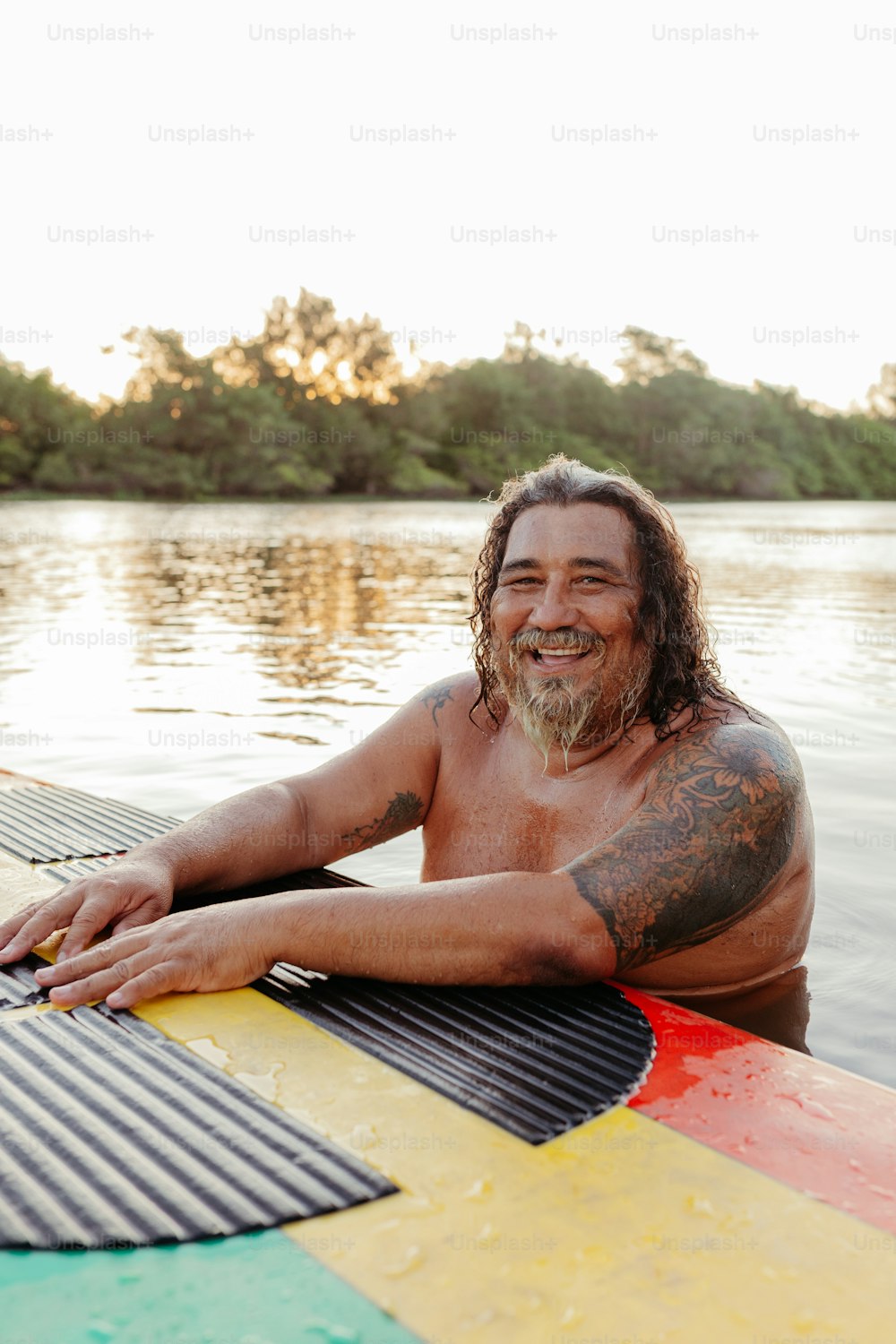 a man sitting on top of a surfboard in the water