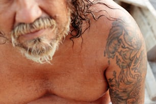 a close up of a man with tattoos on his chest