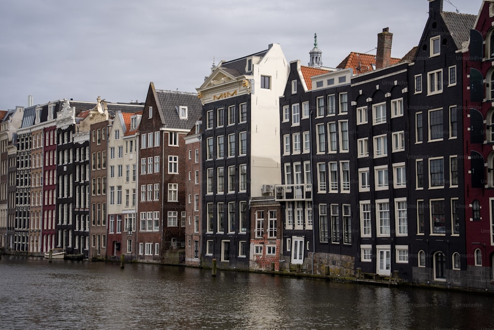 a row of buildings next to a body of water