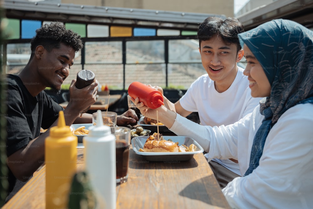 a group of people sitting around a table eating food