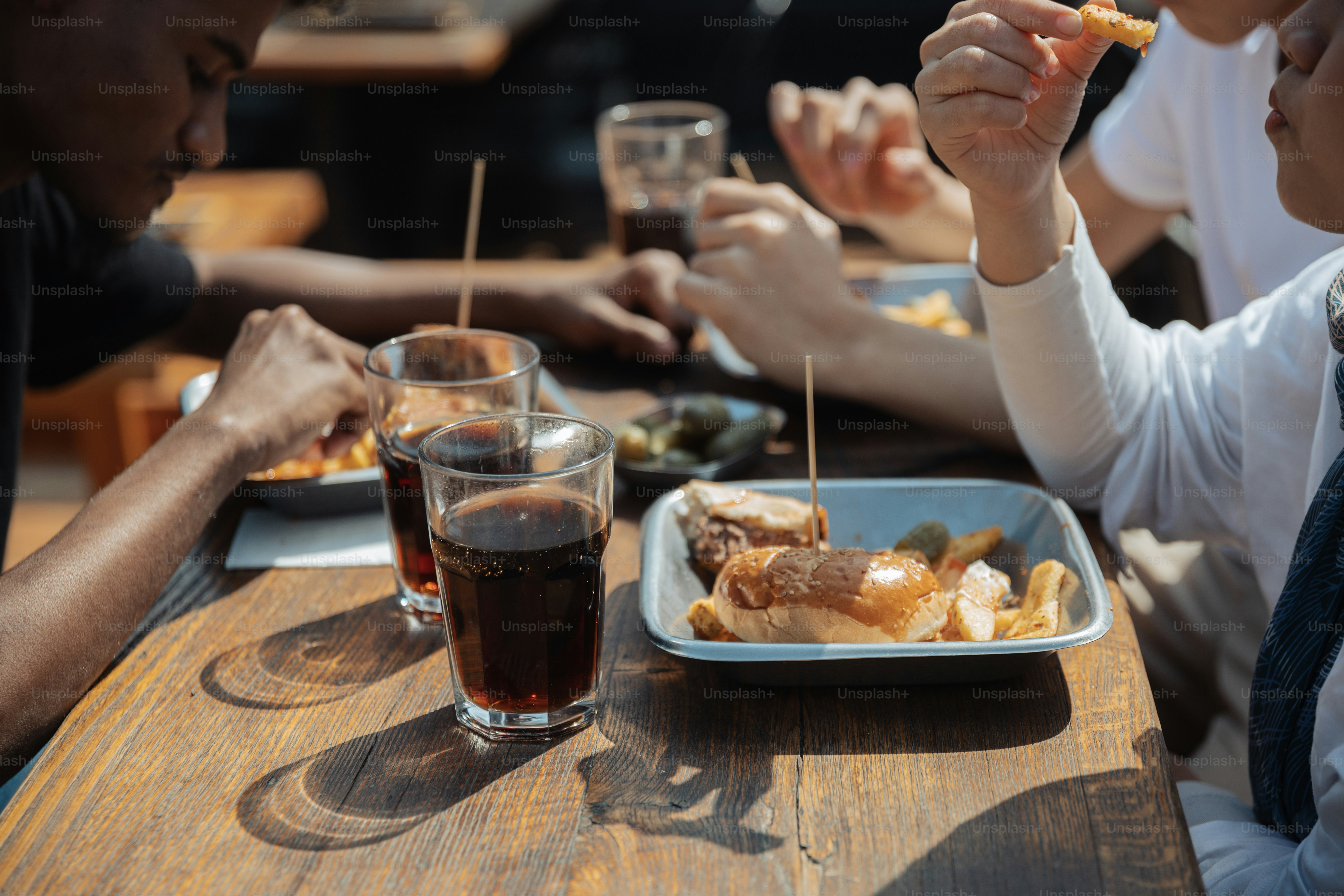 a group of people sitting at a table eating food