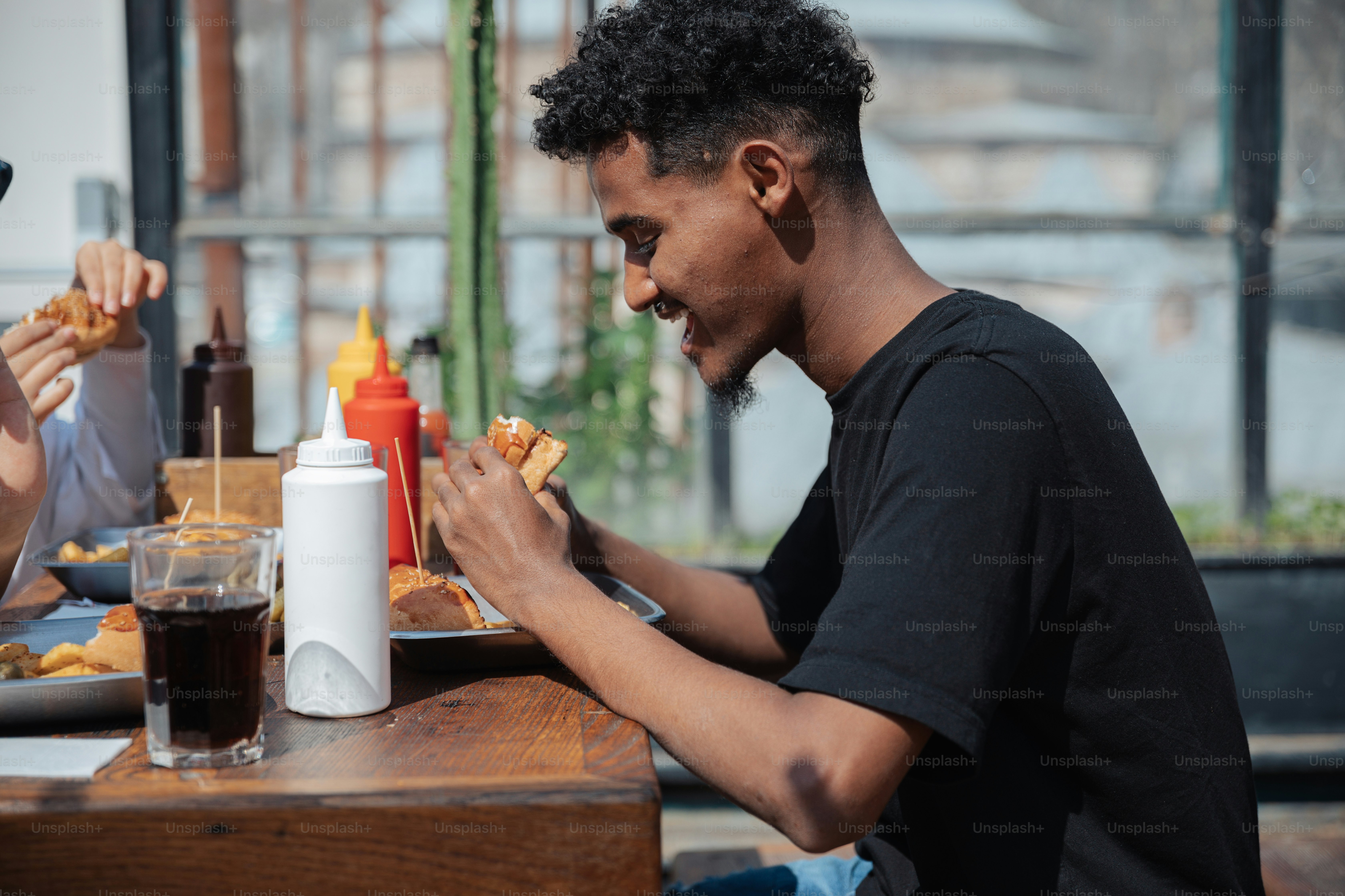 a couple of people sitting at a table eating food