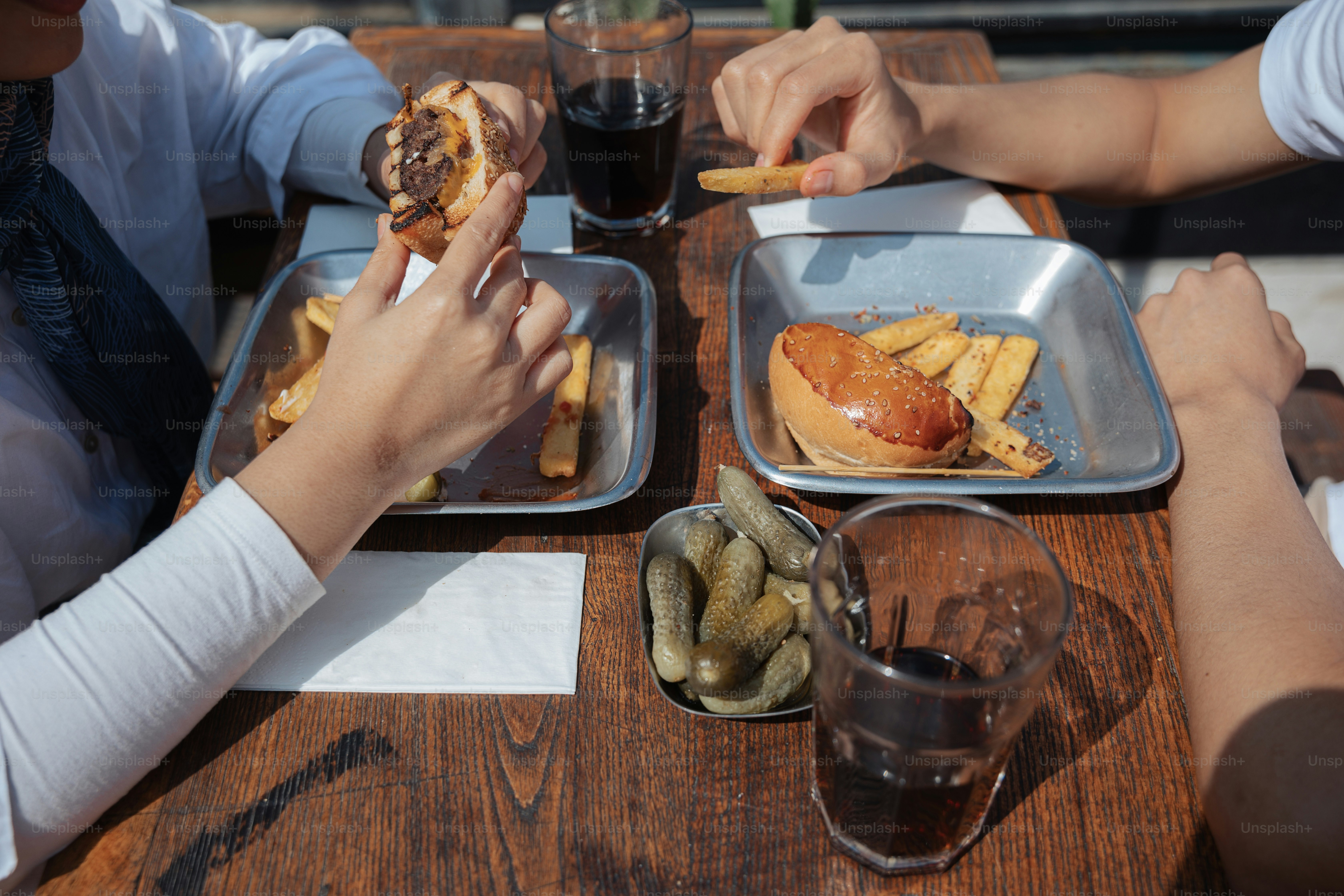 a group of people sitting at a table eating food
