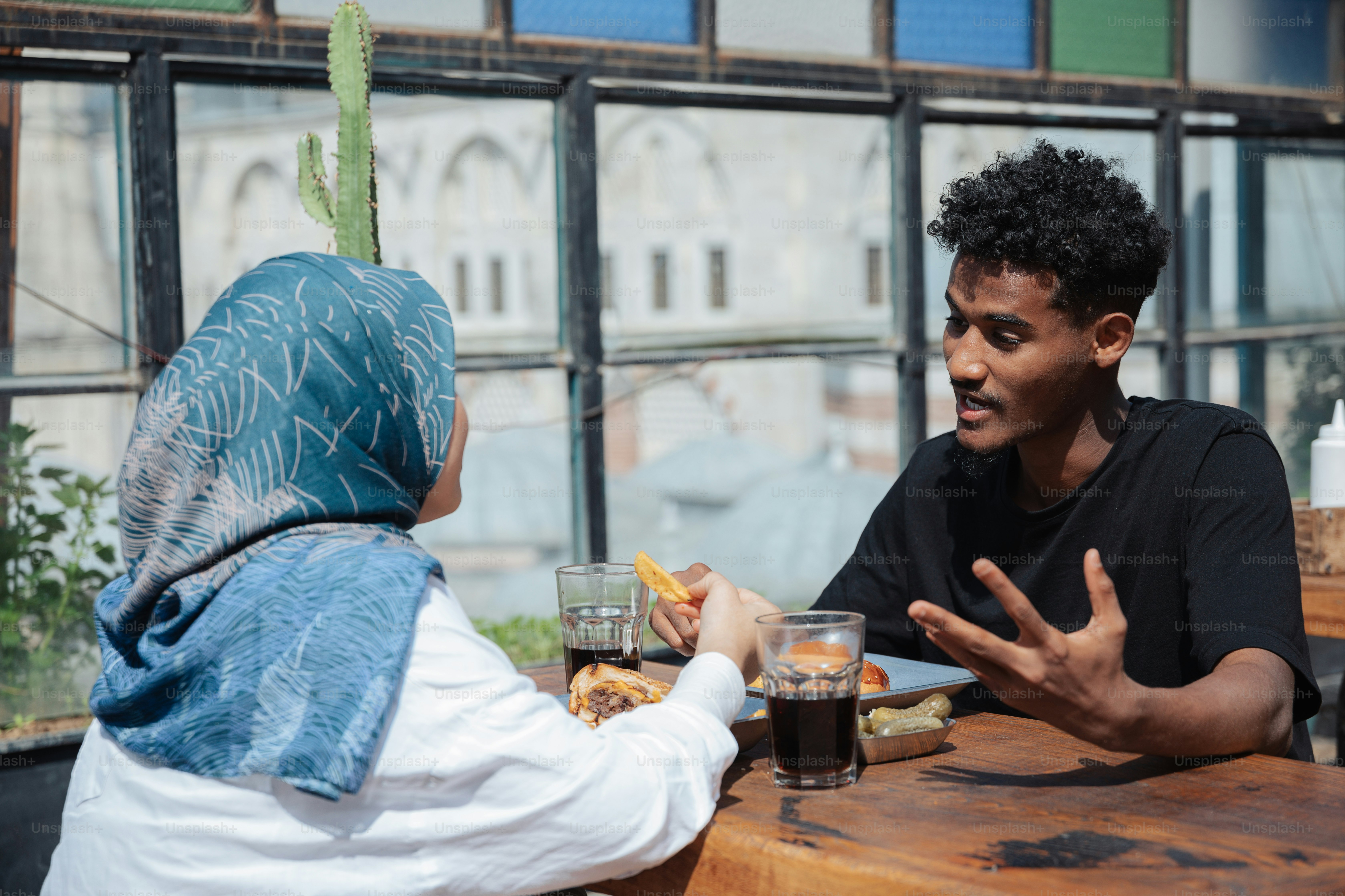 a man and a woman sitting at a table talking