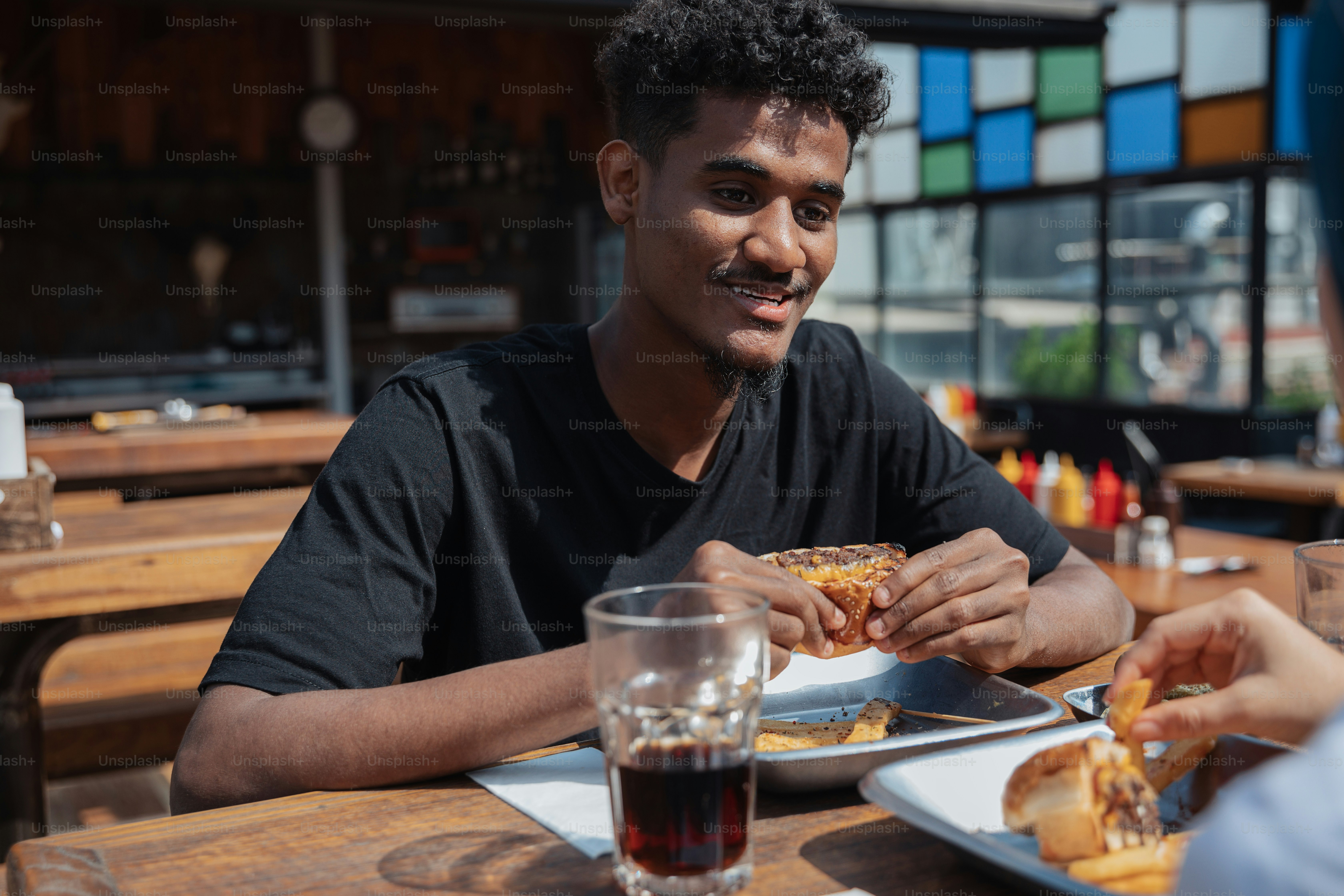 a man sitting at a table with a plate of food