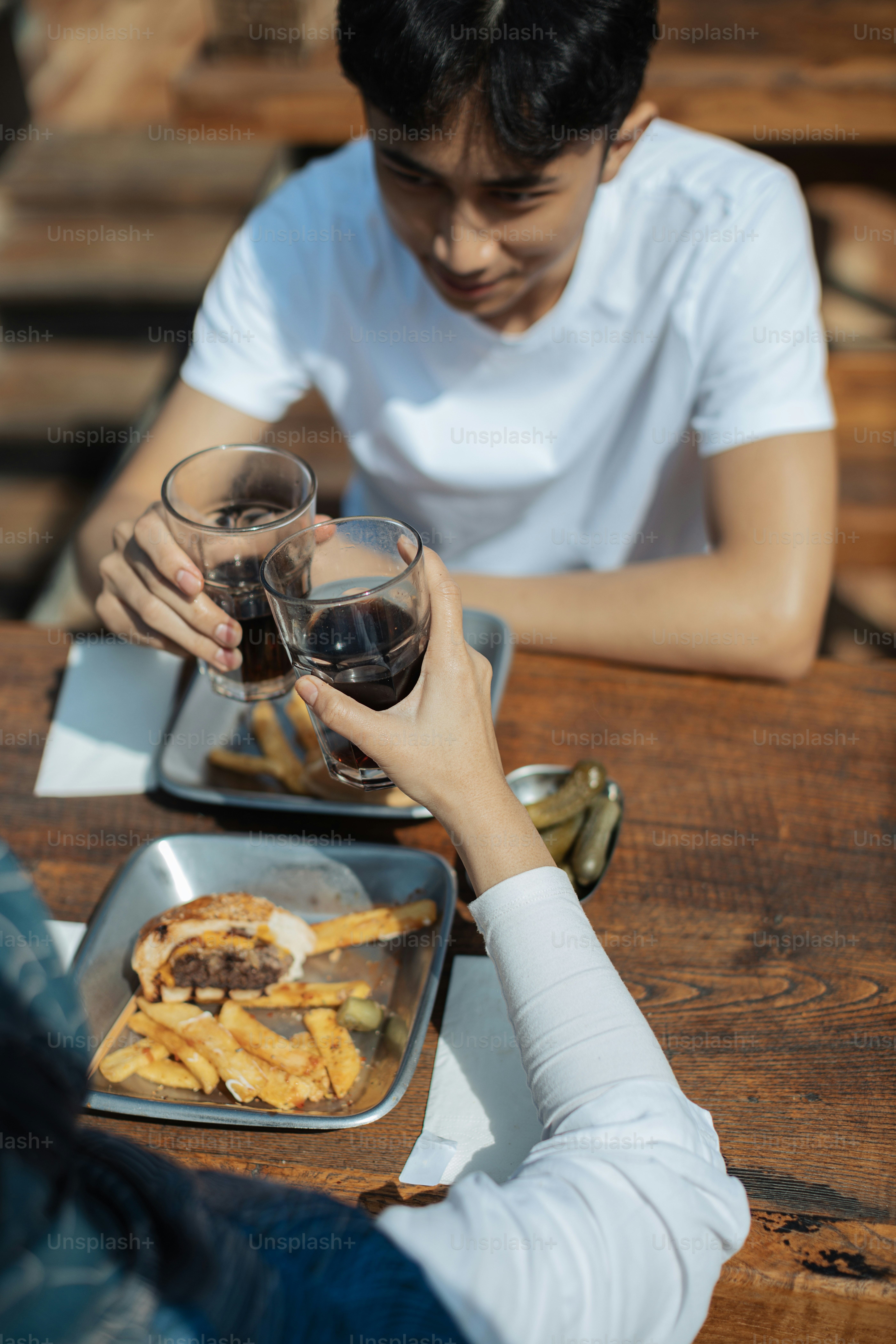 a man and a woman sitting at a table with food