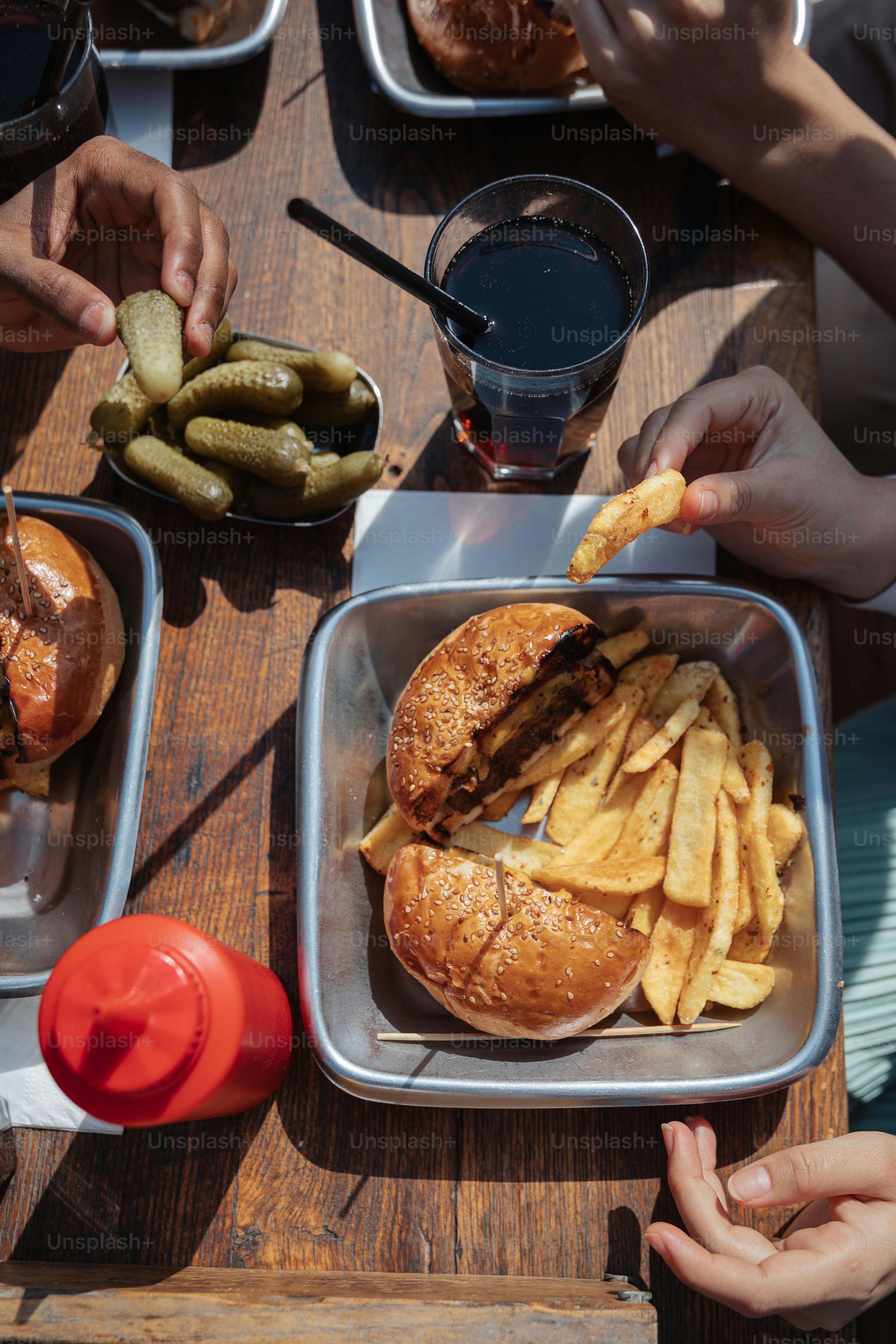 a group of people sitting around a table eating food