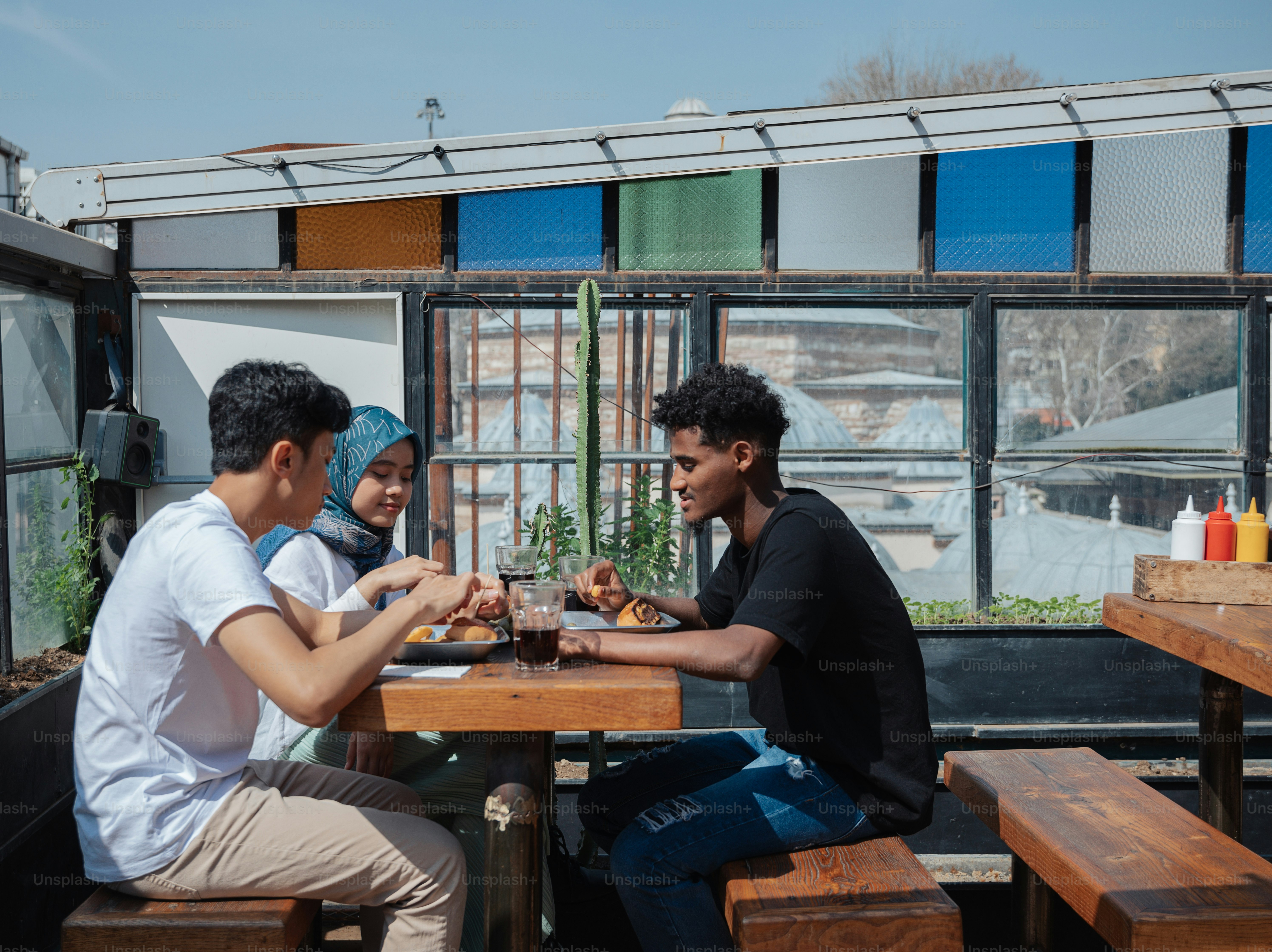 a couple of people sitting at a wooden table