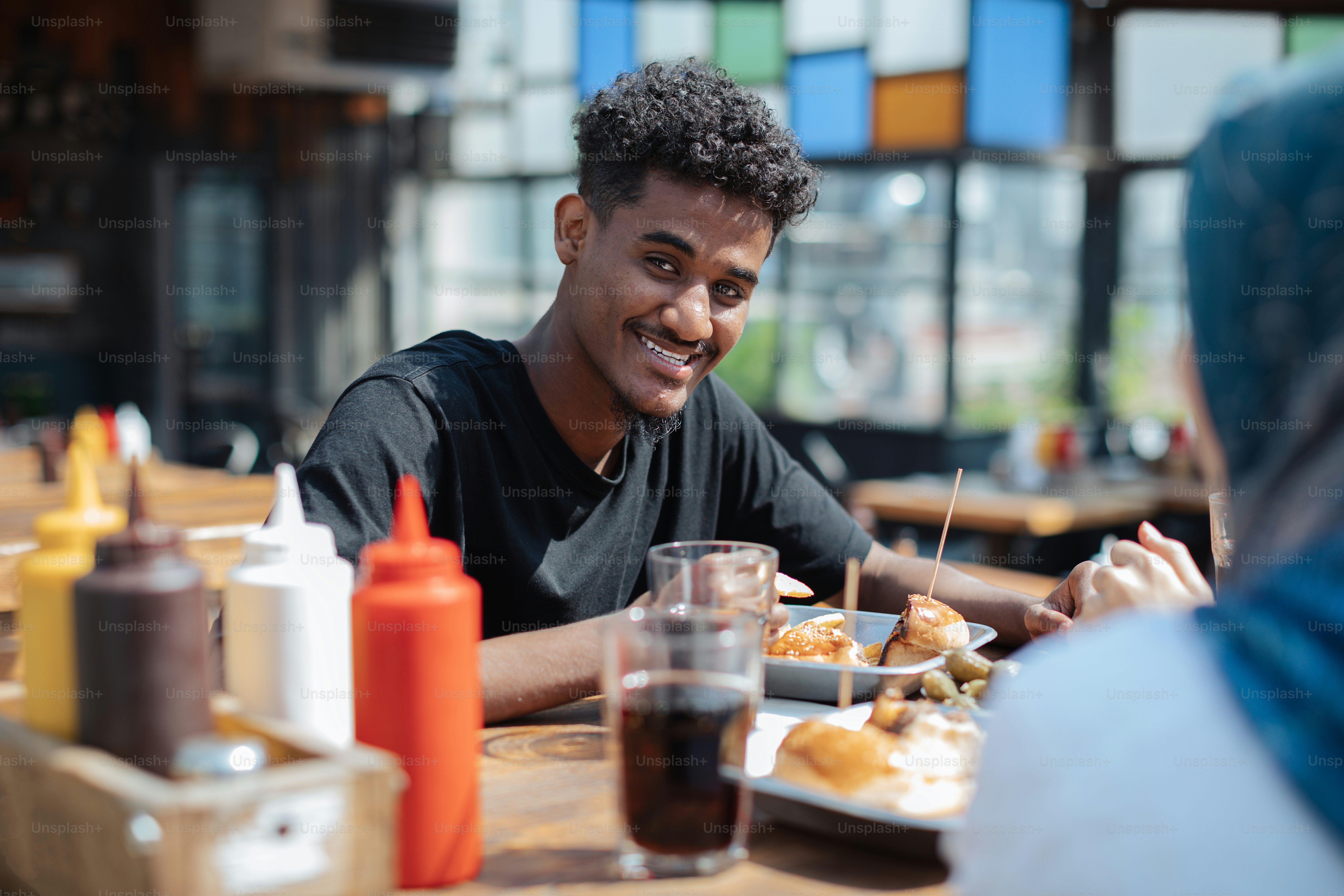 a man sitting at a table with a plate of food