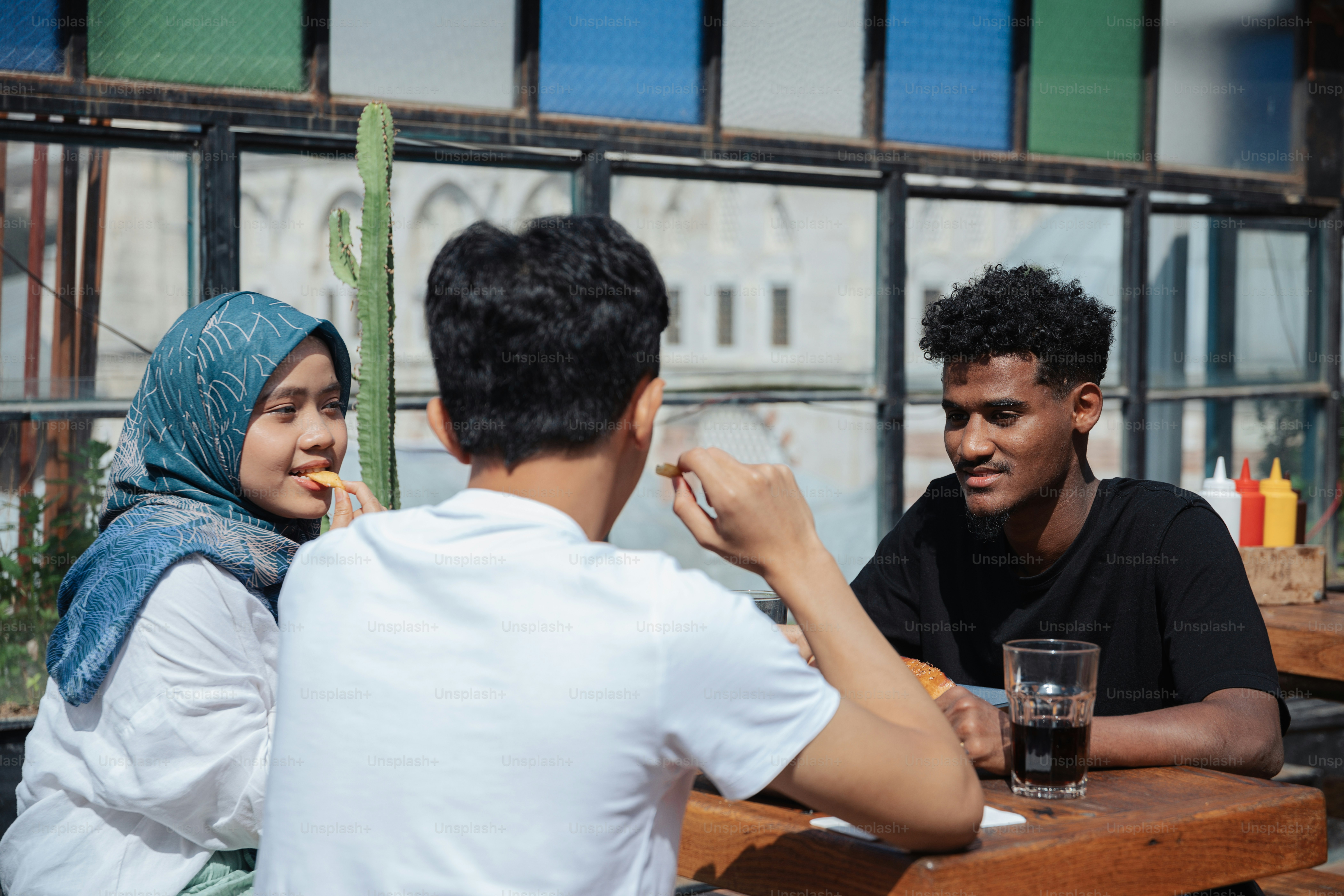 a group of people sitting around a wooden table