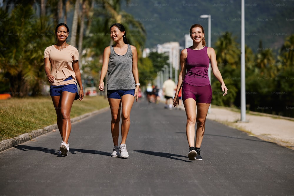Tre donne che camminano insieme lungo una strada
