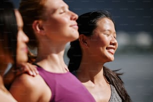 a group of three women standing next to each other