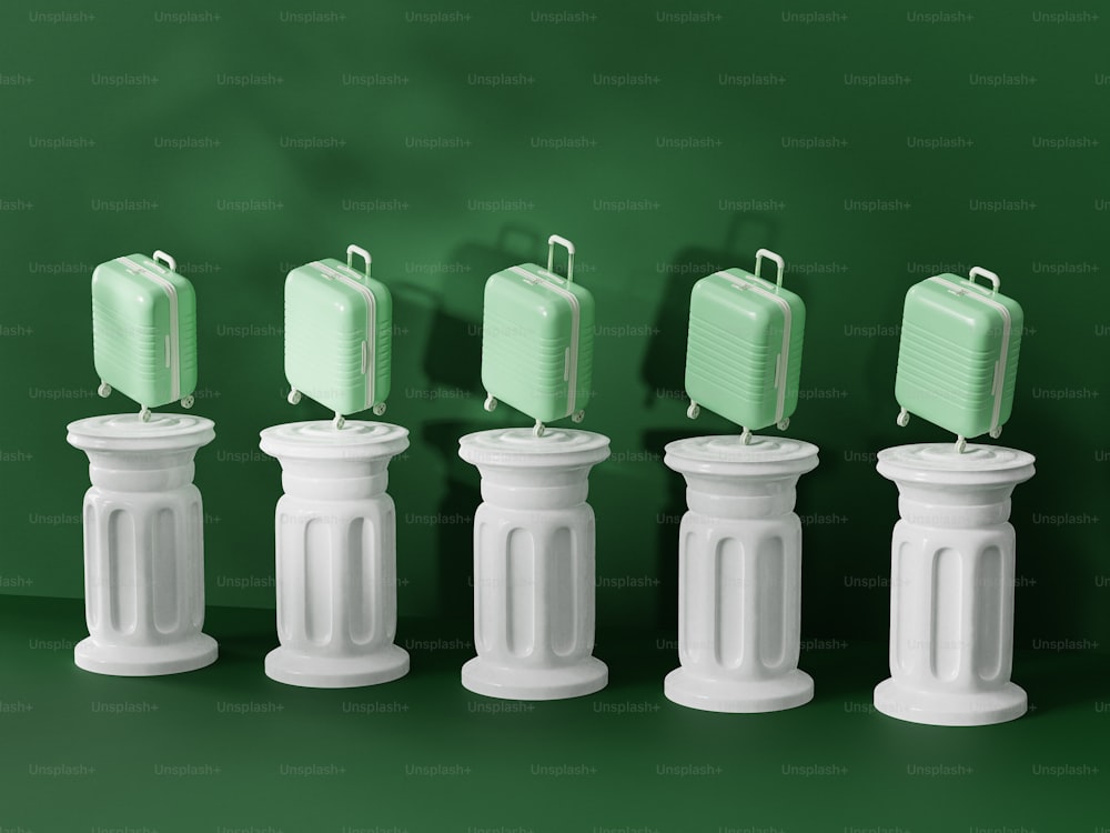 a row of white pedestals with green suitcases on top of them