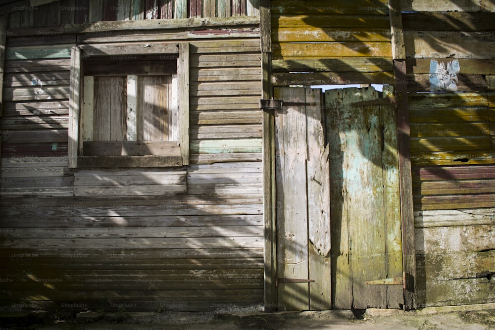 an old wooden building with a door and window