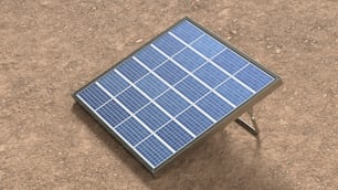 a small solar panel sitting on top of a dirt field