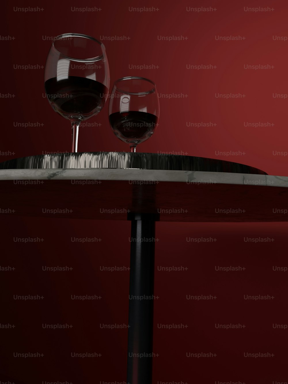 two wine glasses sitting on top of a table