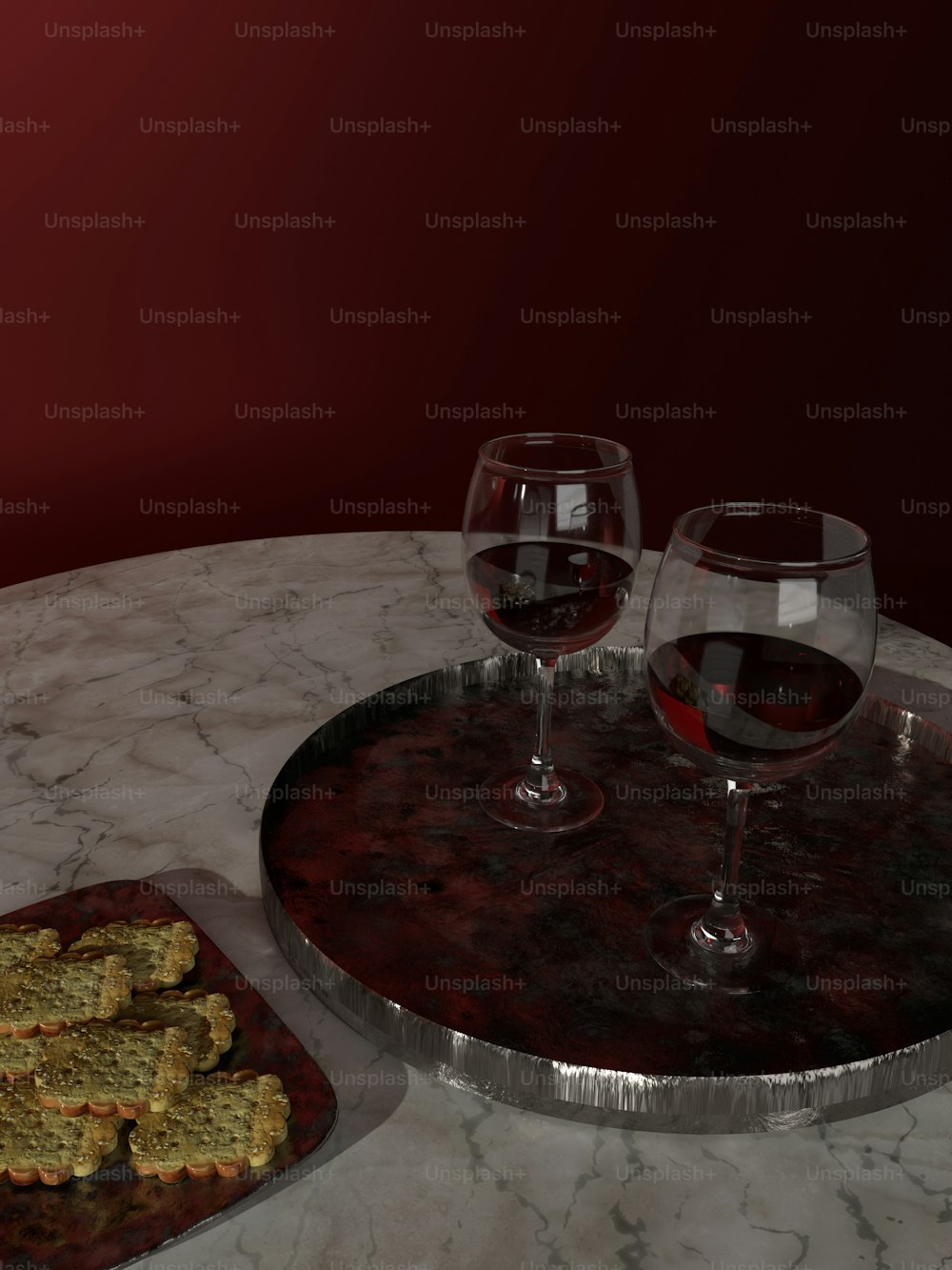 two glasses of wine and a tray of crackers on a marble table