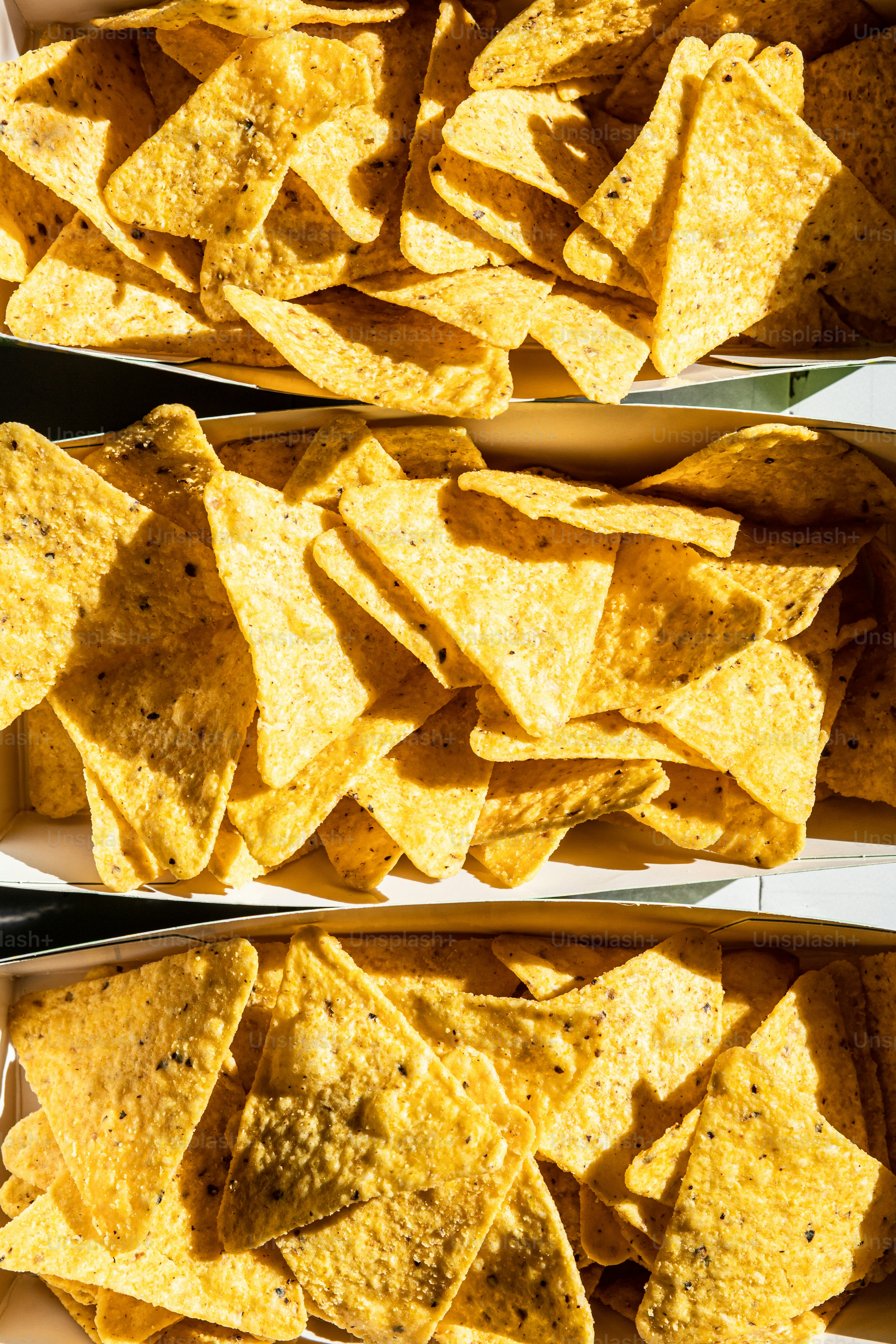 three boxes of tortilla chips on a table