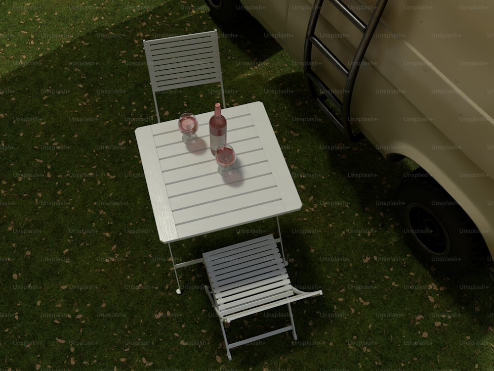 a table and two chairs sitting in the grass