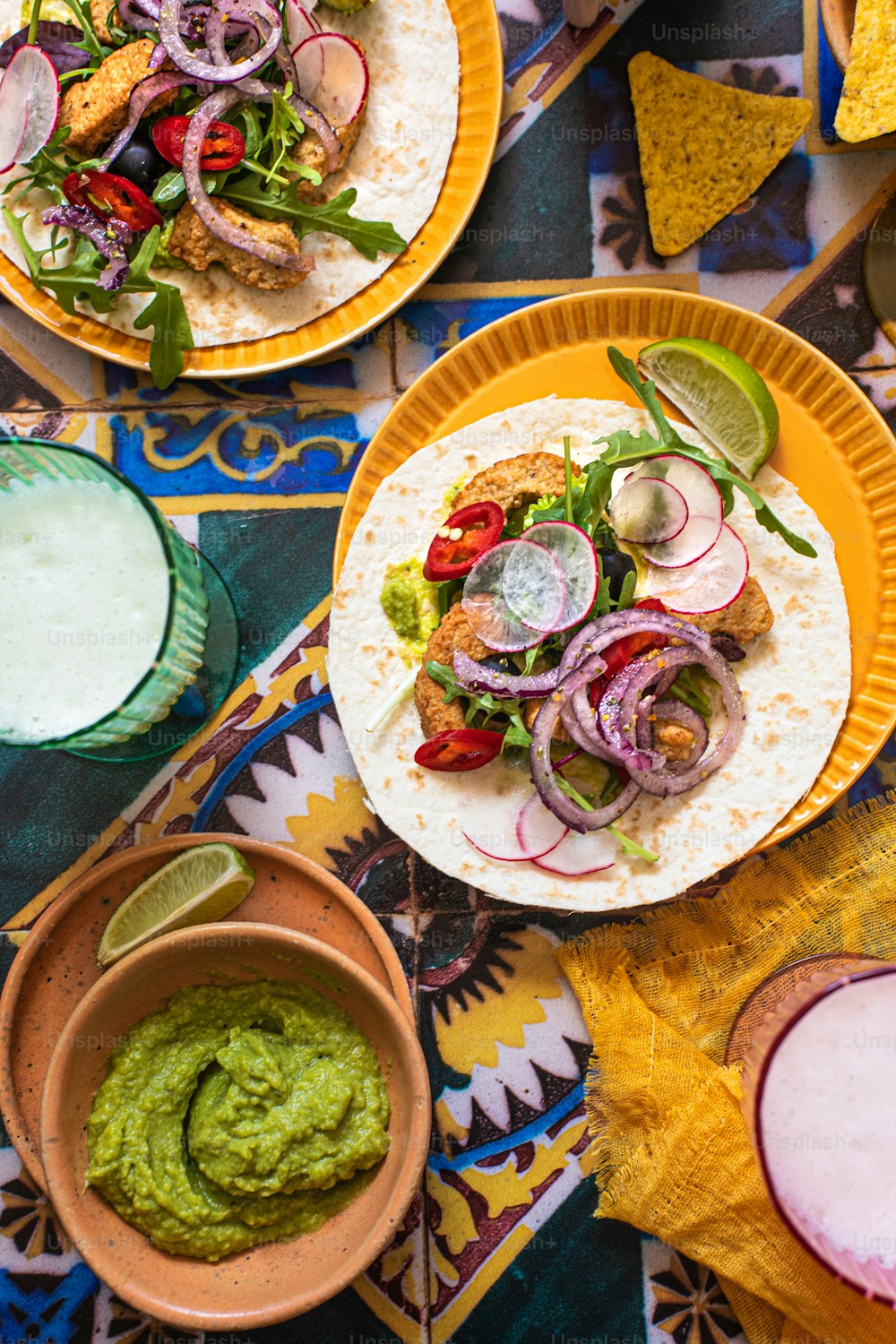 a table topped with plates of food and drinks