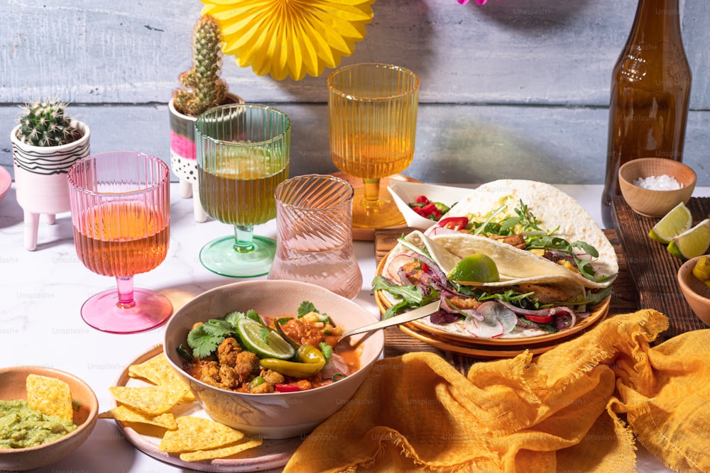 a table topped with bowls of food and drinks