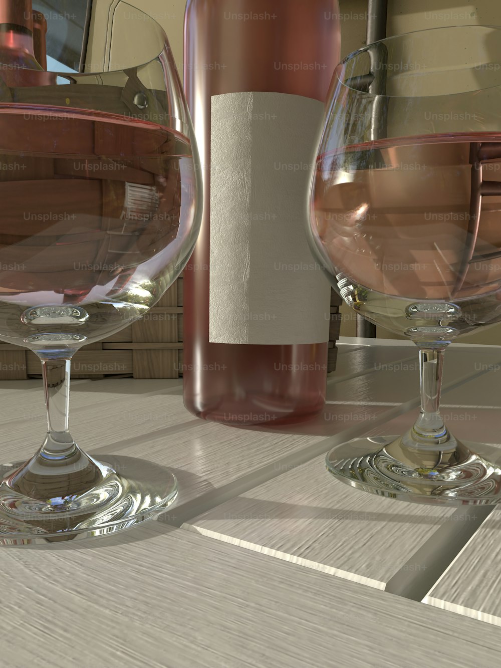 two wine glasses sitting on a table next to a bottle of wine