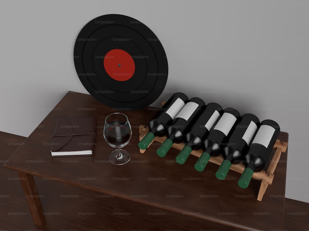 a wooden table topped with bottles of wine and a glass of wine