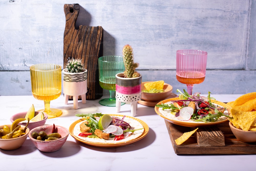 a table topped with plates of food and drinks