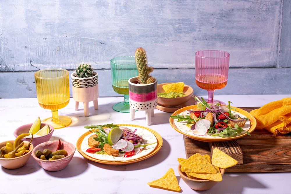 a table topped with plates of food and drinks