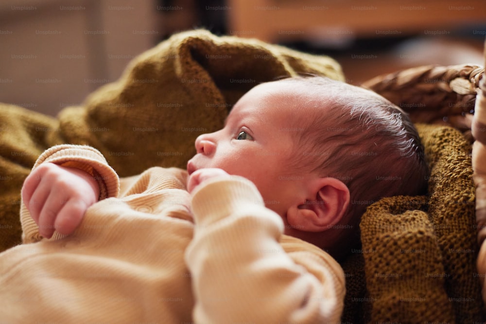 a baby is laying down on a blanket