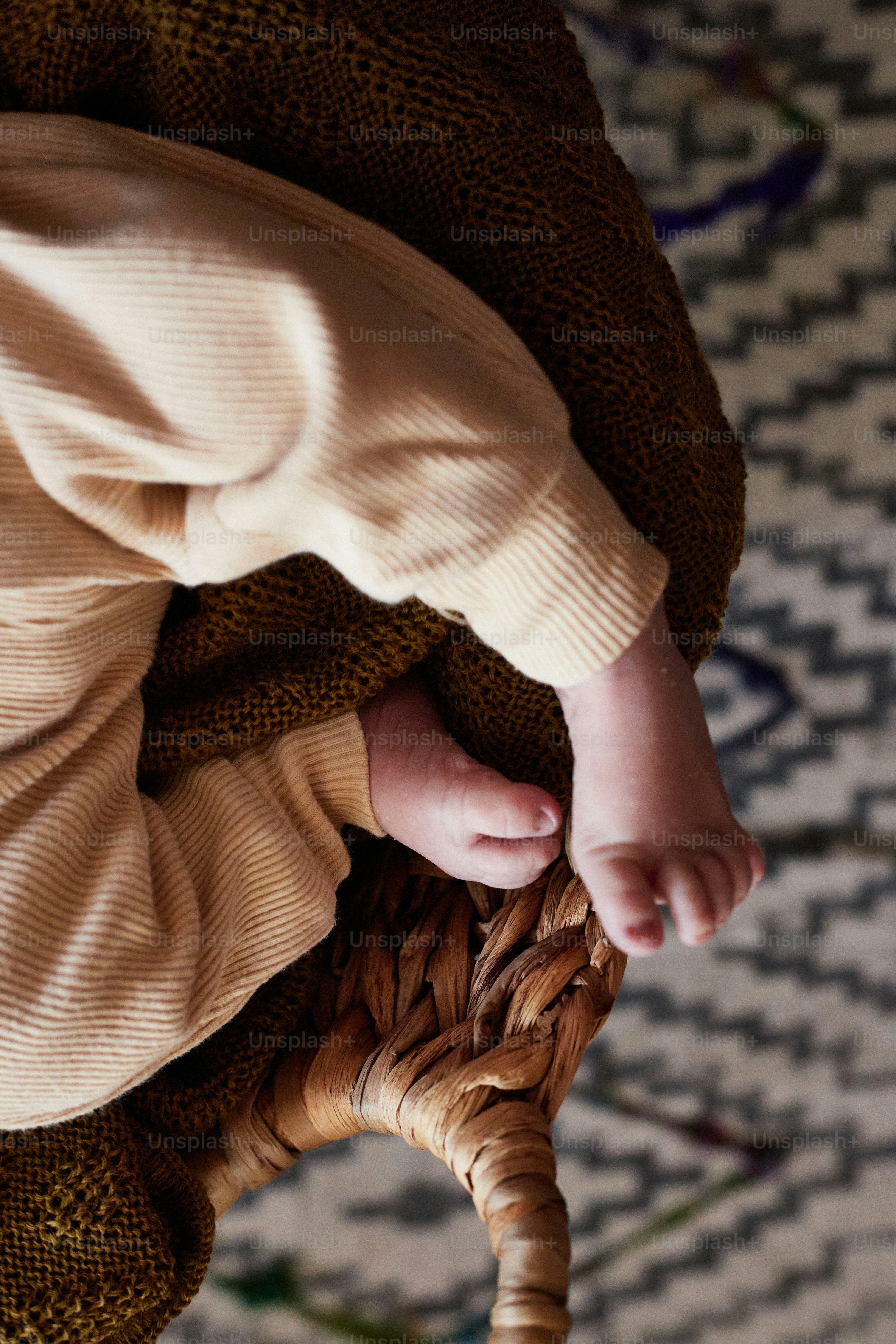 a baby's hand on the back of a chair